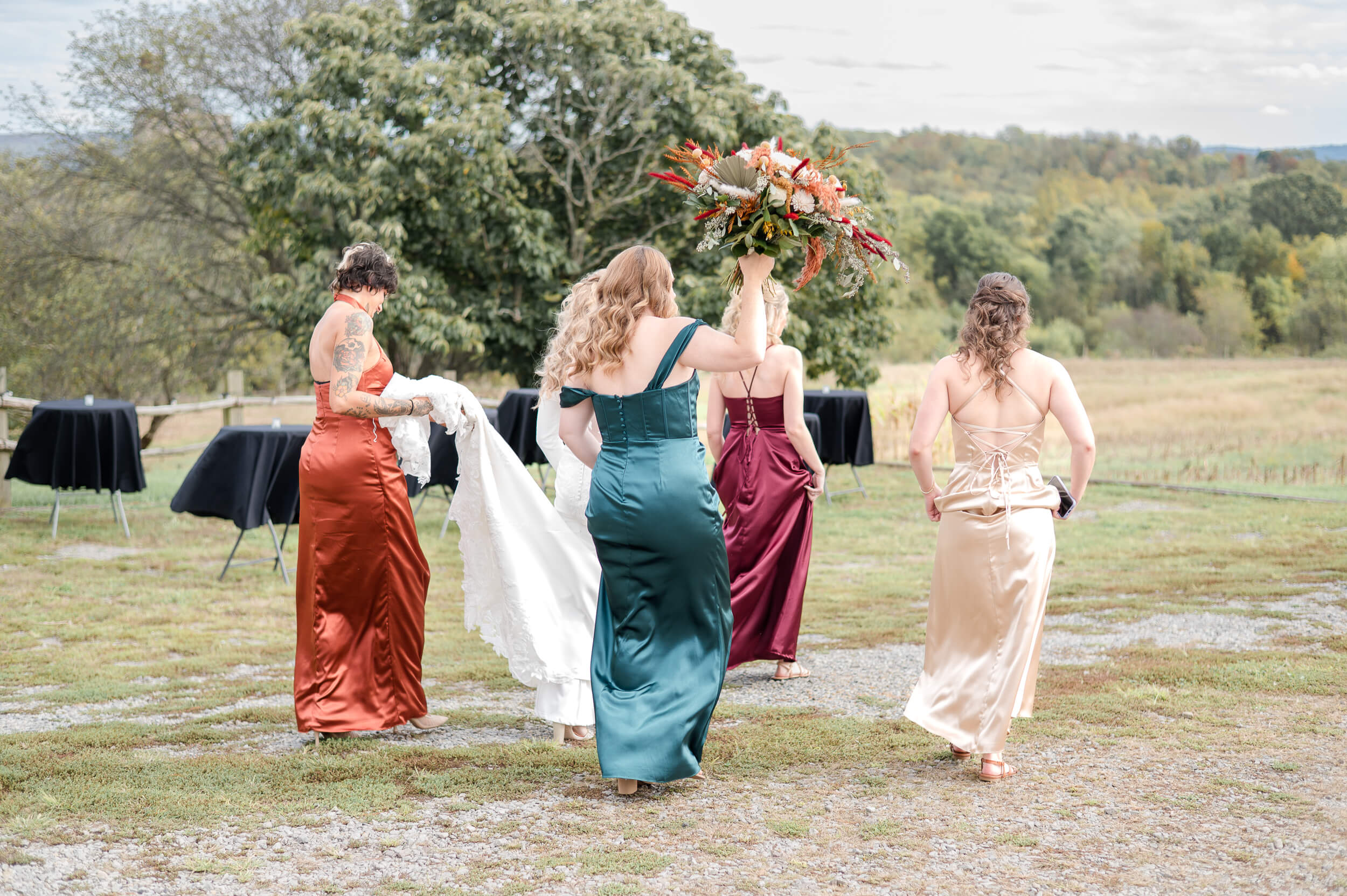Bride and bridesmaids candidly walking outside of Budget friendly wedding venue outside of Pittsburgh, PA.