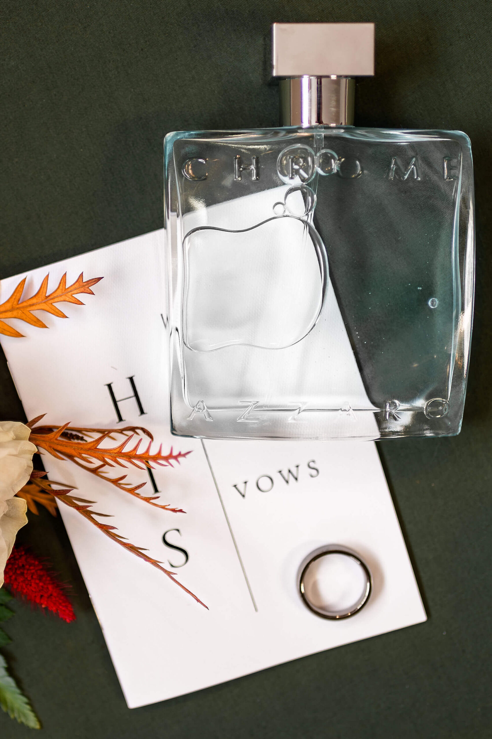 Details of cologne and a wedding band on his vows paper at one of the Pennsylvania weddings