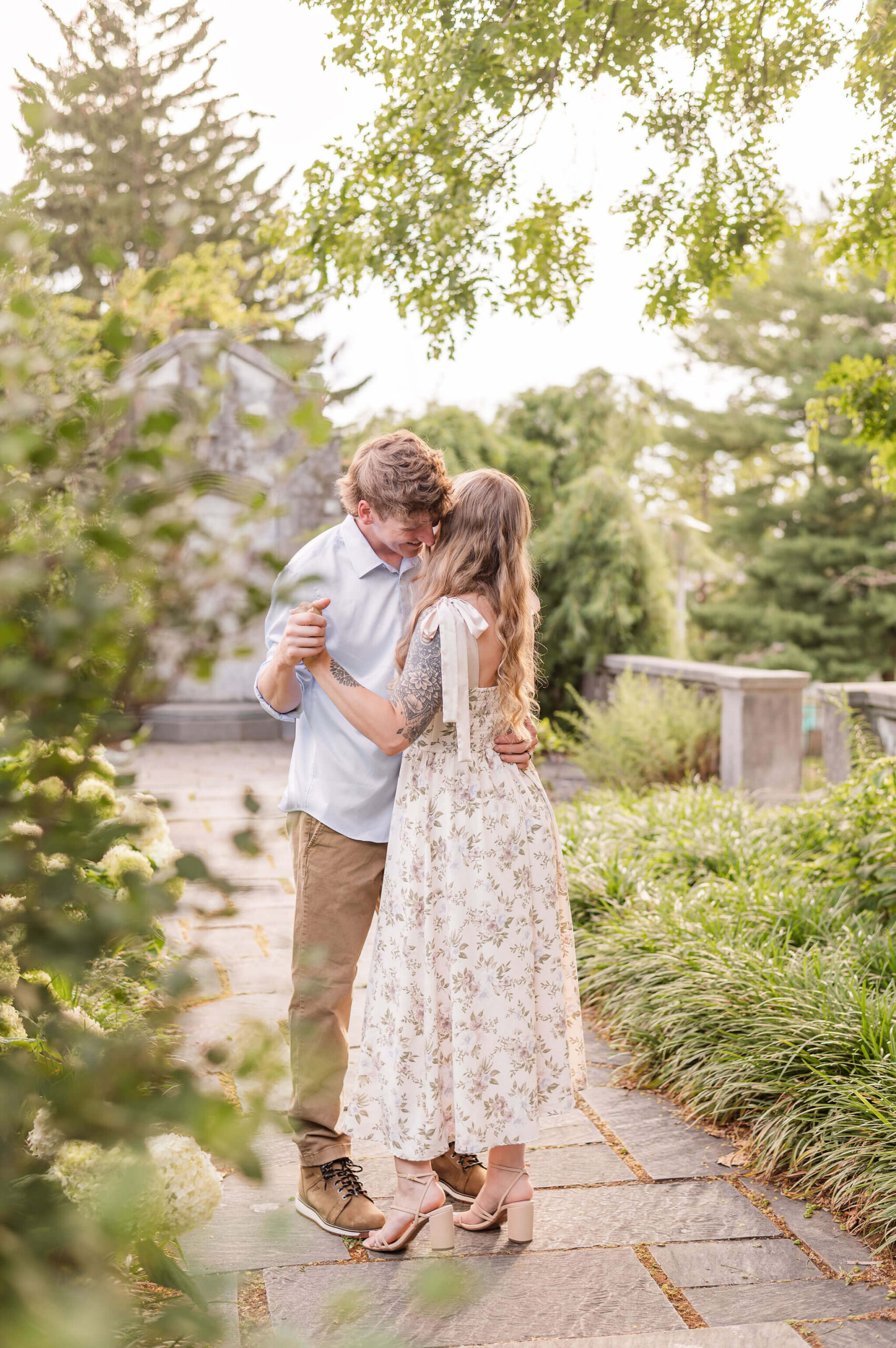 Engaged couple dancing in the Walled Garden during Mellon Park engagement photos in Pittsburgh.
