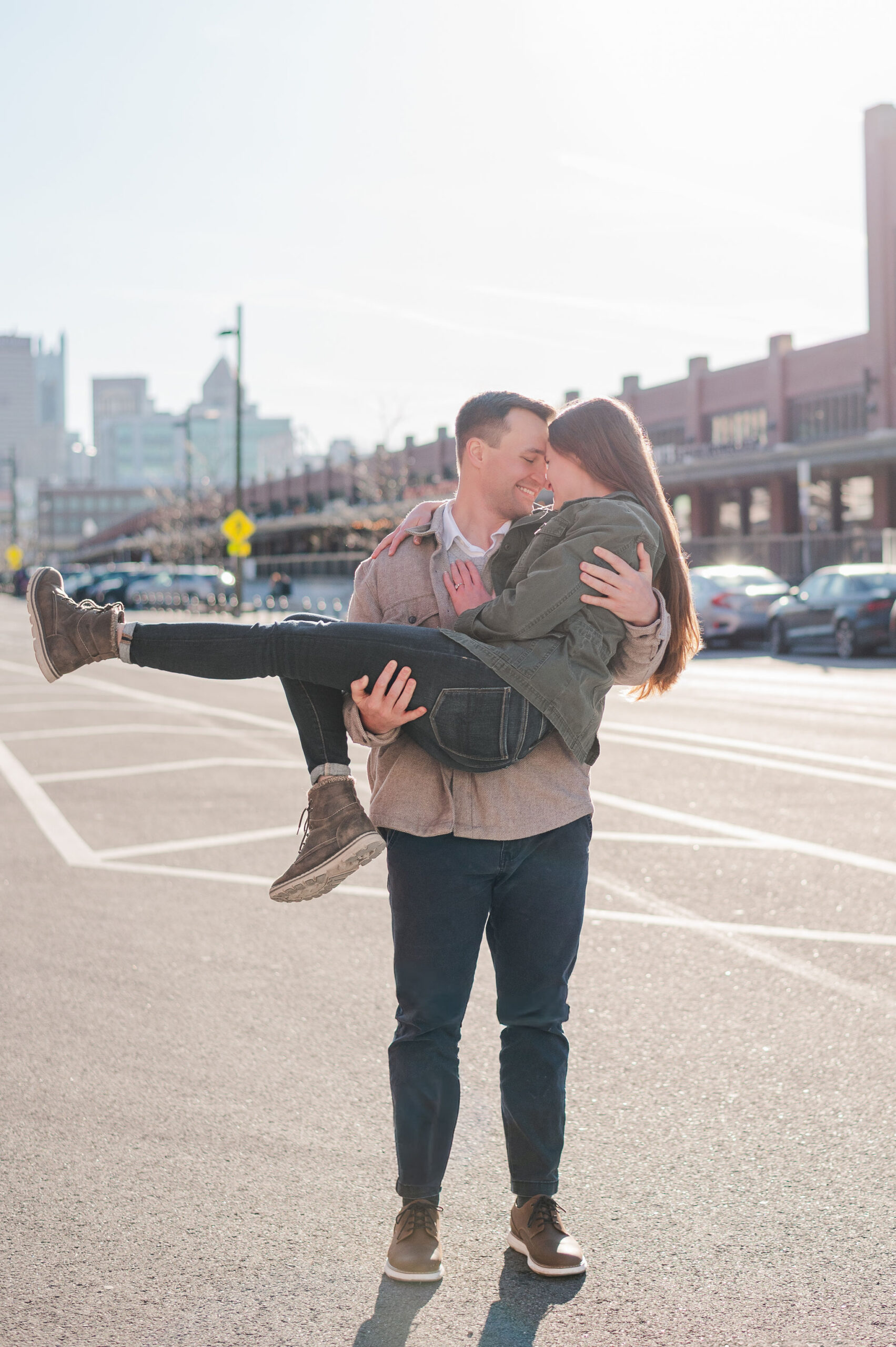 Couple holding each other while standing in the street of the Strip District. 