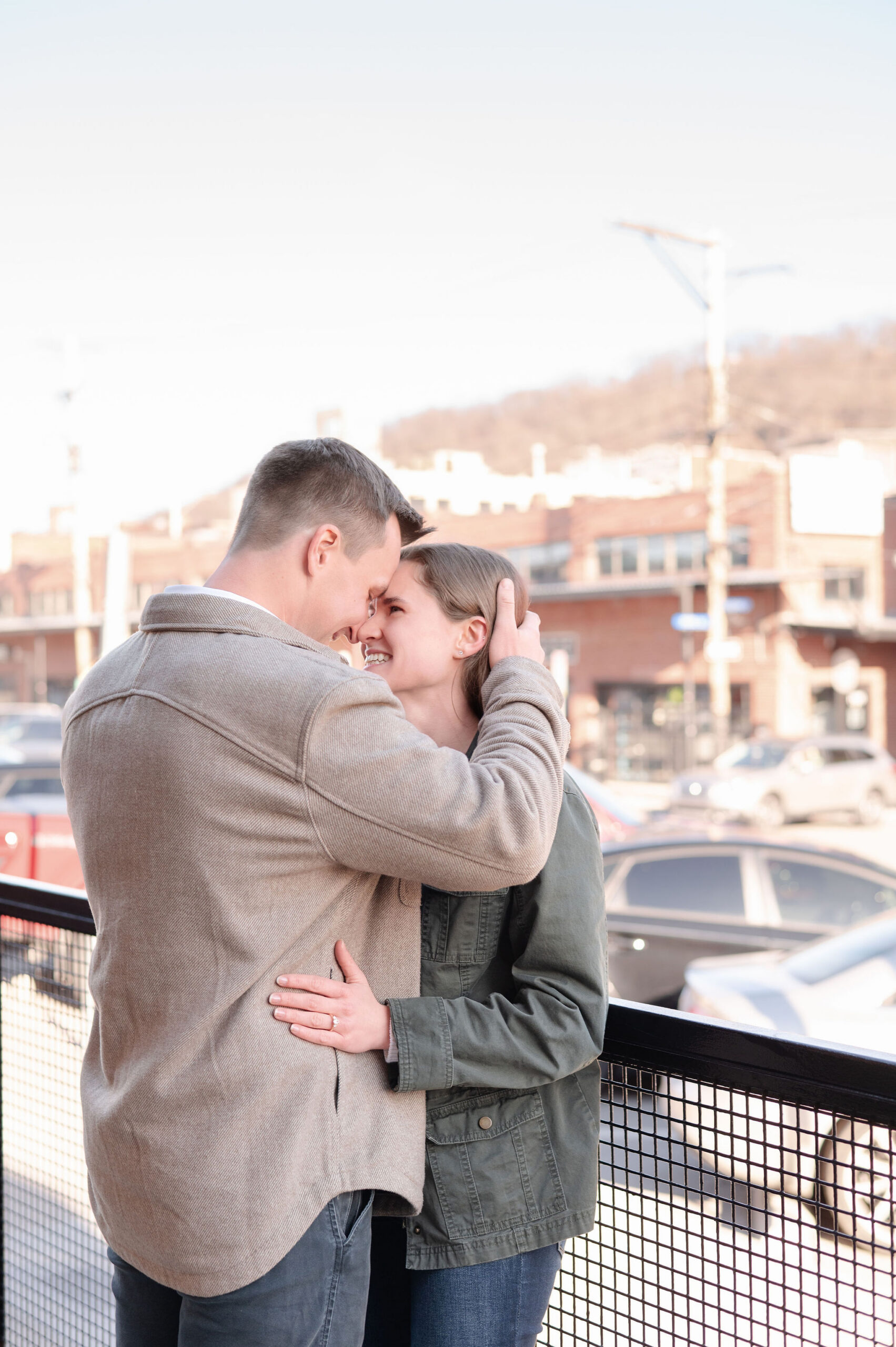 Close-up of couple touching foreheads and smiling softly.