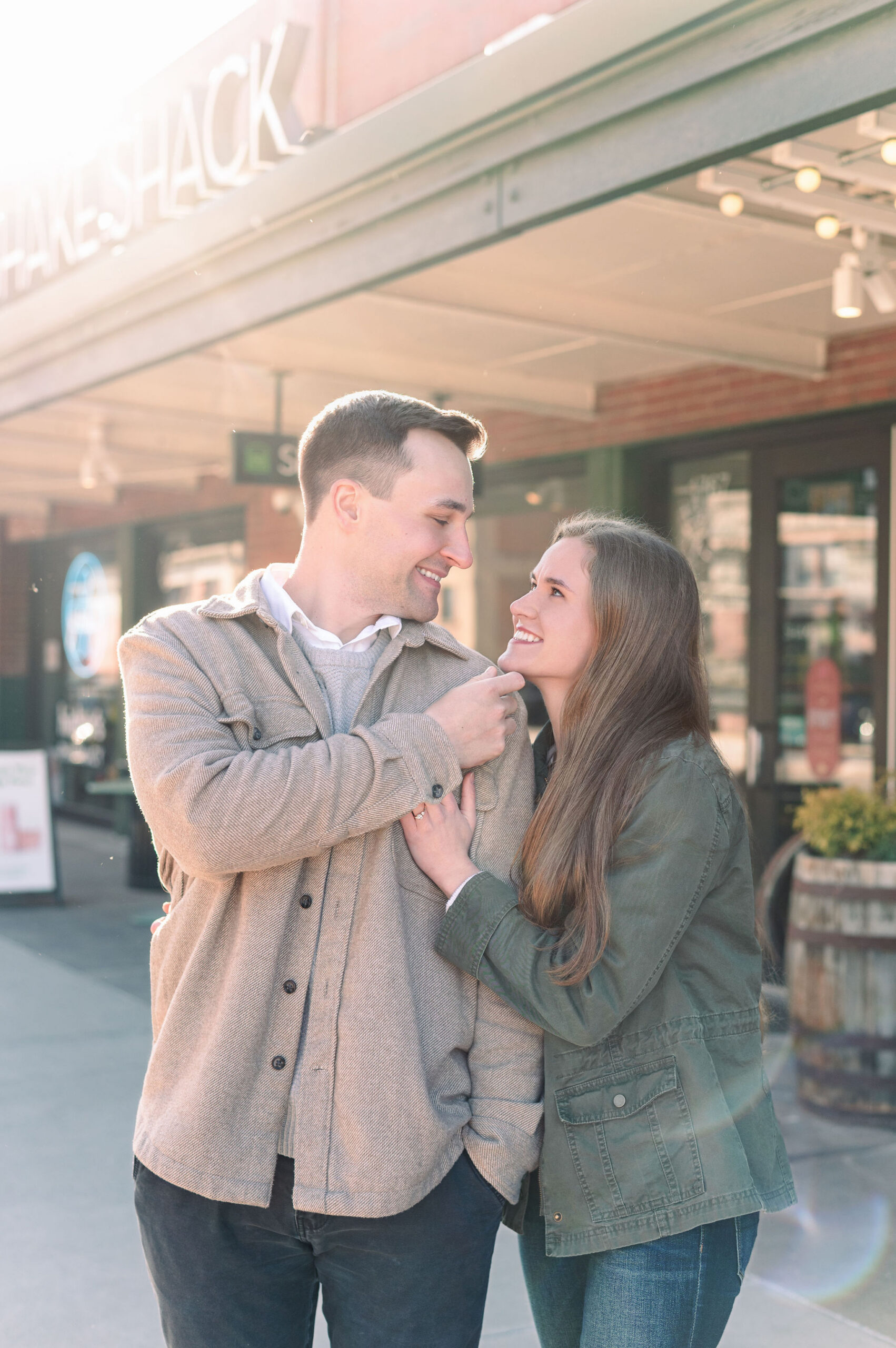 Couple sharing a warm moment together in soft light for their Pittsburgh engagement photos.
